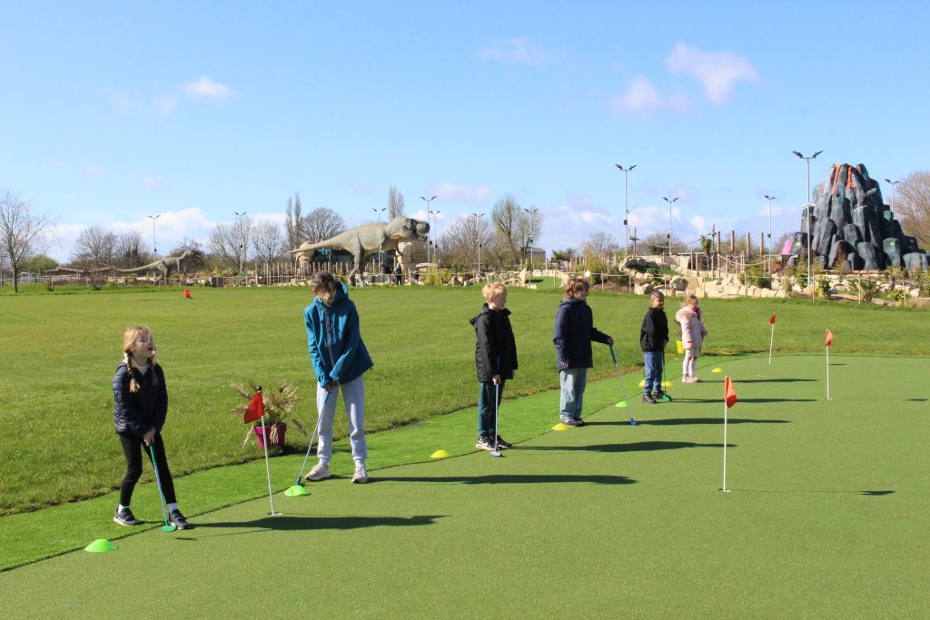 Youngsters enjoying mini golf